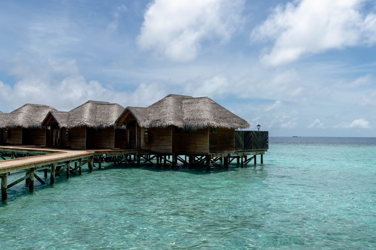 Overwater villas over a turquoise Maldives lagoon