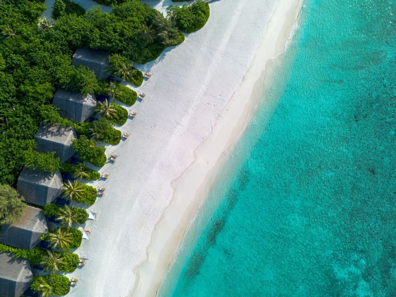Aerial view of a Maldives island resort and lagoon
