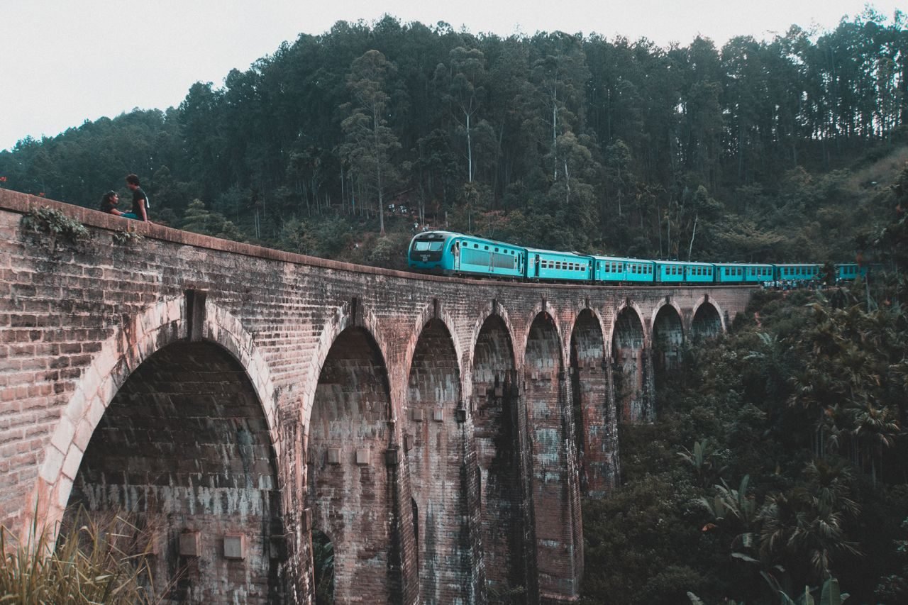 A blue train crossing the Nine Arch Bridge, Ella, Sri Lanka